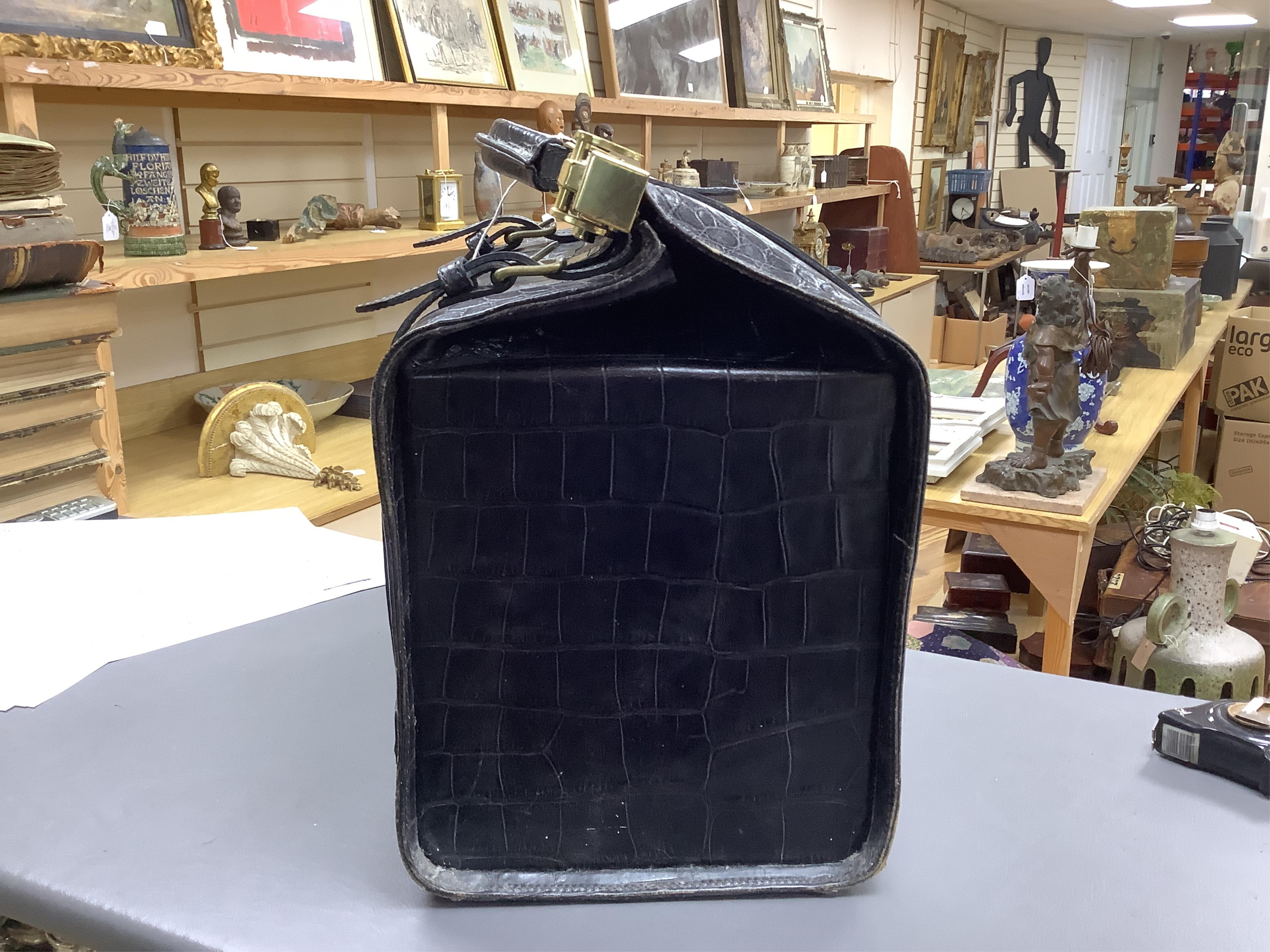 A 1940’s ladies crocodile skin Gladstone bag with gilt metal hardware, 34cm wide